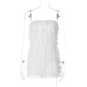 Detail view of white lace strapless romper with tiered ruffles and bow tie detail