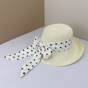 Beige woven straw sun hat with elegant black polka dot bow for beach summer vacation