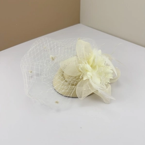 Elegant cream fascinator hat with delicate mesh veil, floral accents and soft feathers