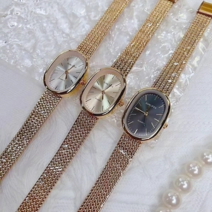 Elegant gold mesh band quartz watch set with oval dials in silver and black colors