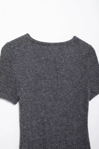 Detailed macro view of gray knitted fabric texture and collar seam on short sleeve dress