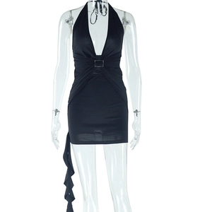 Detail view of deep V-neckline with decorative metal buckle on black halter mini dress