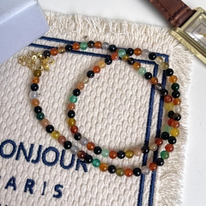 Minimalist 925 sterling silver colorful beaded necklace with adjustable gold clasp on fabric
