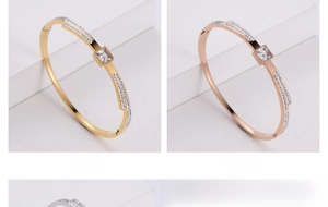 Close-up of gold and rose gold titanium steel bangles with square acrylic rhinestones