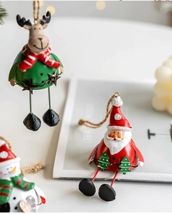 Close-up of festive Christmas metal pendants featuring Santa and Reindeer with twine ropes