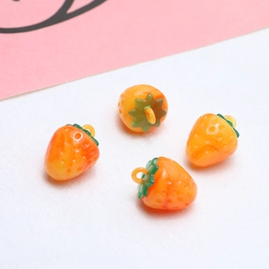 Detailed view of four orange resin strawberry charms with green leaves for DIY jewelry