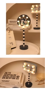 Detail of wooden Christmas LED table lights with Santa and Penguin patterns