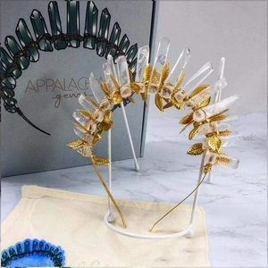 Handmade crown with natural white crystals and golden leaves on a sleek headband