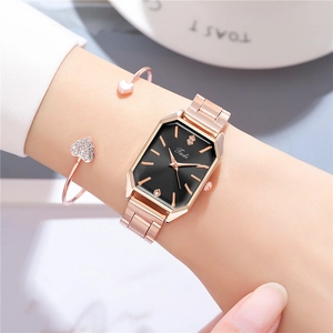Elegant rose gold rectangular watch with black dial and matching heart charm bracelet