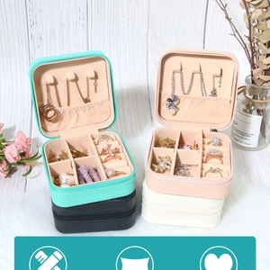Detailed interior of portable jewelry box showing hooks, ring slots, and organizers