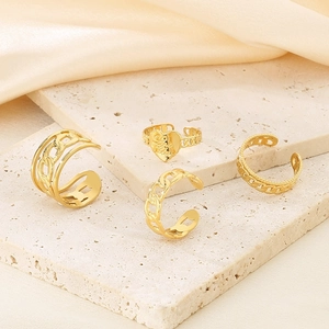 Chic twisted gold open ring set with heart engraving and layered chain design on marble