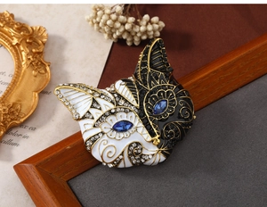Close-up of vintage fox brooch with blue rhinestone eyes and enamel finish