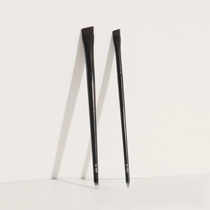 Detail view of two black angled makeup brushes A-101 and A-102 on a clean white background