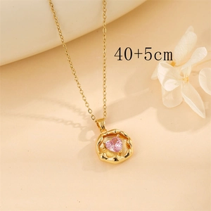 Detail of gold heart necklace featuring a pink zircon pendant and 40+5cm chain size
