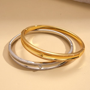 Macro detail of 18k gold plated bangle featuring zircon gourd buckle and pave setting