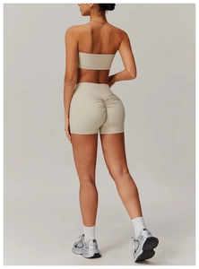 Detail of high-waisted beige scrunch yoga shorts showing butt-lifting seam and fit