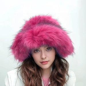 Detail of fluffy faux raccoon fur hat in rose red with thick warm punk style texture
