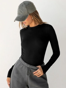 Close-up of black ribbed knit long sleeve T-shirt showing fabric texture and slim fit