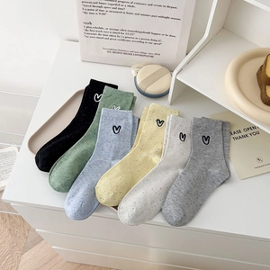 Women embroidered heart polka dot mid-calf socks in six colors shown on white table