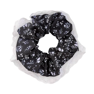 12cm floral hair scrunchie in black fabric with white lace trim on white background