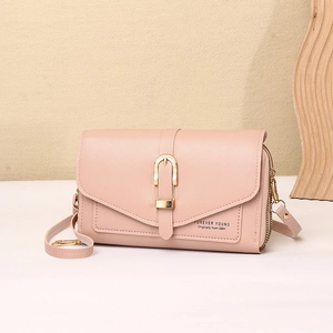 Detail view of pink leather phone bag with gold metal buckle and dual zipper compartments