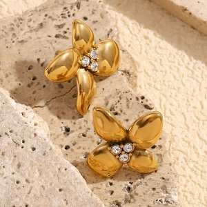 Macro shot of 18K gold plated flower stud earrings with white zircon on stone