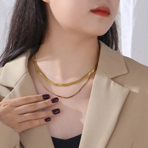 Double-layered 18k gold plated titanium steel flat herringbone chain necklace on a model