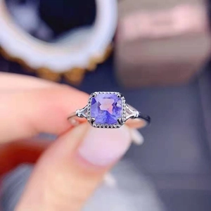 Elegant princess cut lavender gemstone ring with sparkling diamond halo and silver band