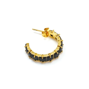Detailed view of gold C-shape earrings with square-cut black zircon stone inlay
