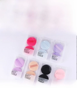 Macro shot of two round makeup puffs in colorful professional beauty tool packaging