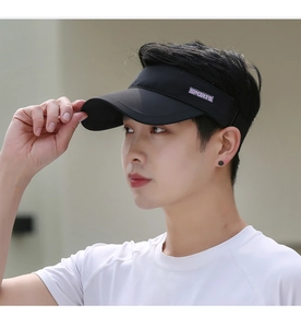 Side view of black sun visor with purple Sports logo on male model for outdoor activities
