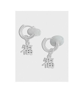 Macro view of S925 silver hoop earrings with green jade beads and Fu character charms