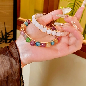 Detailed view of handmade tiger eye and crystal beaded bracelet with gold wire wrapping