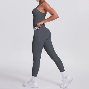Detail view of dark grey yoga set featuring functional side pockets for mobile phone storage
