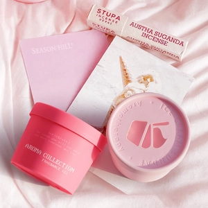 Pink car fragrance gel and aromatherapy solid balm set on soft fabric background