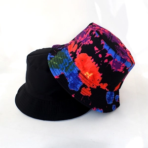 Detail view of black and colorful abstract print reversible bucket hats for street fashion