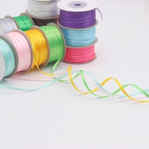 Macro shot of 3mm double-faced satin ribbons in multiple colors for DIY gift wrapping