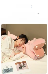 Cozy pink hippo plush pillow shown in a home bedroom scene for comfortable sleeping