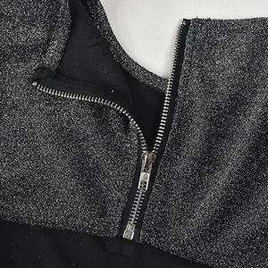 Detail of silver glitter fabric and metallic zipper on high-stretch sexy jumpsuit