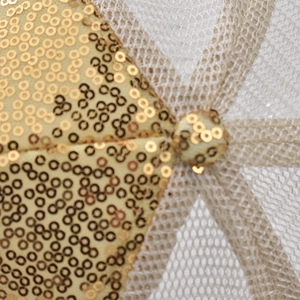 Macro shot of shimmering gold sequins and champagne mesh on a stylish breathable mesh cap