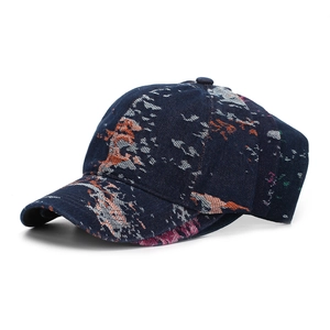 Detailed close-up of dark blue baseball cap with colorful floral jacquard texture