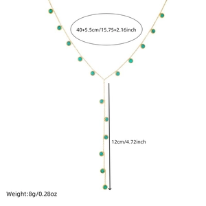 Gold Y-shaped necklace with turquoise beads and geometric circular details on white base