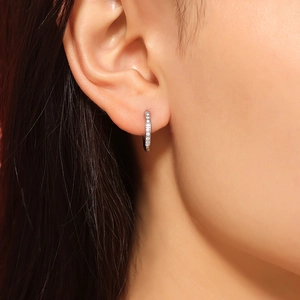 Silver PVD coated titanium steel hoop earrings with sparkling cubic zirconia on model
