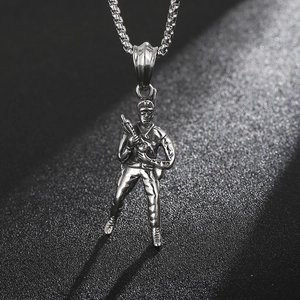 Detailed close-up of a vintage steel soldier pendant holding a rifle with metallic chain