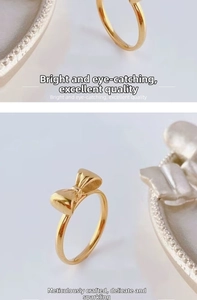 Macro detail of a golden bow ring with a polished metallic finish and elegant 3D folds