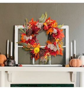 Autumn wreath detail showing maple leaves, sunflowers, and pumpkins on a white window frame
