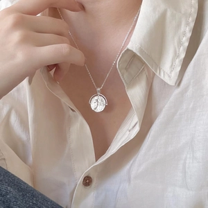925 sterling silver coin pendant necklace with queen embossed relief on silk background