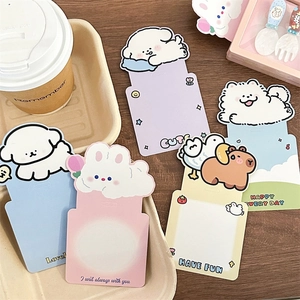 Flat lay of colorful cartoon storage boxes with animal designs on a wooden desk