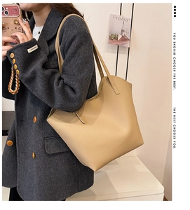 Detailed side view of beige leather tote bag with lychee texture worn by a model