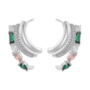 Detail of multi-layer C-shape silver earrings with green and pink gemstones